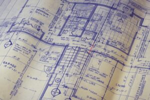 Detailed architectural blueprint of a home layout with a red line drawn between the kitchen and living areas.