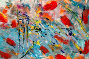 A PIECE OF ABSTRACT ART, WITH VIBRANT RED, BLUES AND YELLOWS.
